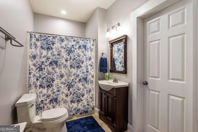 bathroom featuring vanity, toilet, and walk in shower