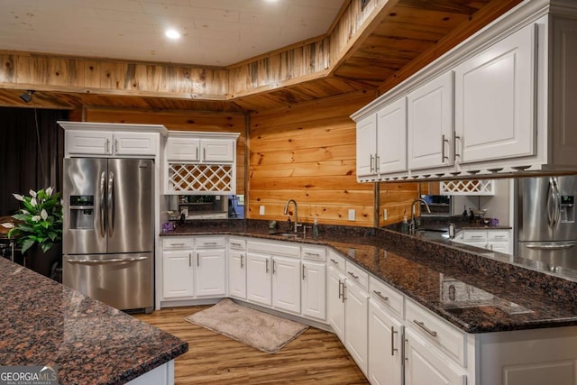 kitchen featuring white cabinetry and stainless steel fridge