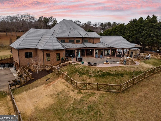 back house at dusk with a patio