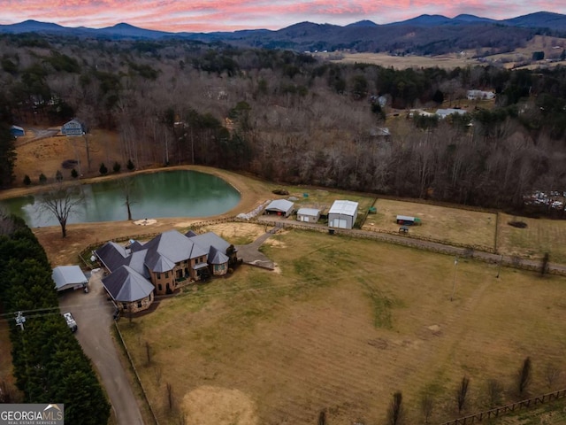 aerial view at dusk with a water and mountain view