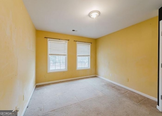 spare room with light colored carpet