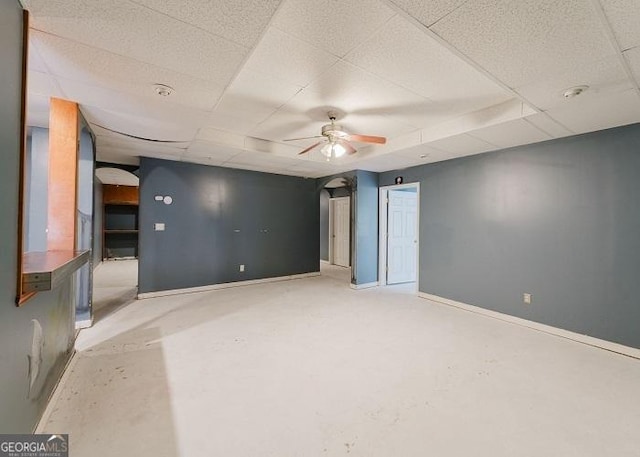 unfurnished room featuring ceiling fan and a drop ceiling