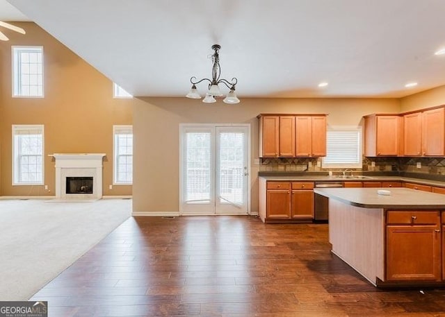 kitchen with tasteful backsplash, pendant lighting, dark hardwood / wood-style flooring, and a center island