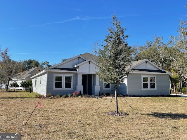 single story home with a front yard