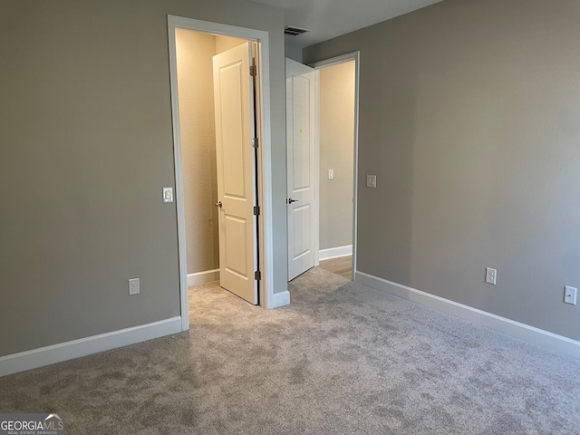 unfurnished bedroom with light colored carpet