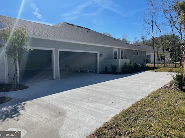 rear view of property with a garage