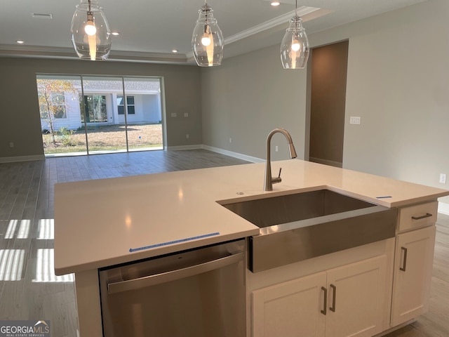 kitchen with pendant lighting, sink, a kitchen island with sink, white cabinetry, and stainless steel dishwasher