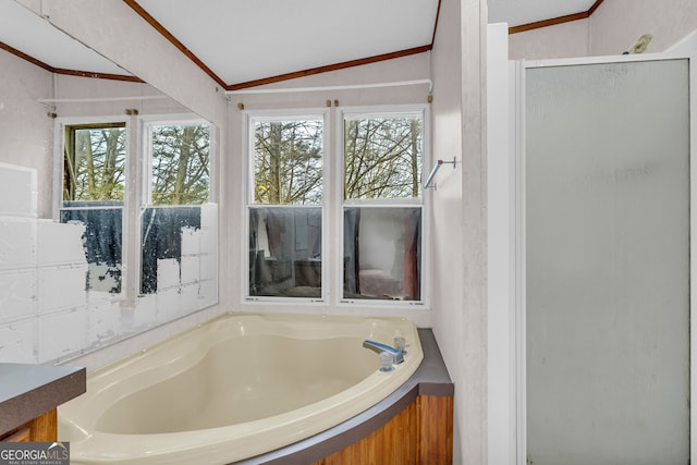 bathroom featuring ornamental molding, lofted ceiling, and shower with separate bathtub