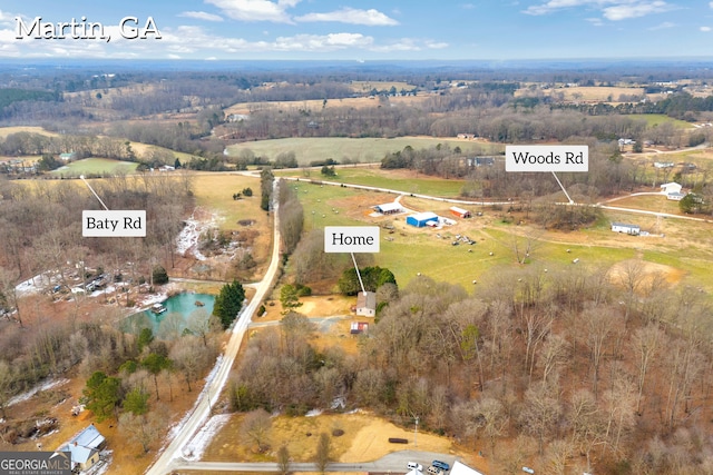 birds eye view of property featuring a rural view