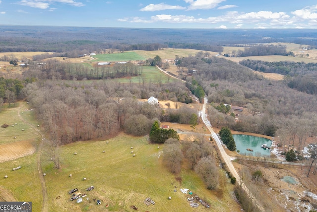 birds eye view of property featuring a water view and a rural view