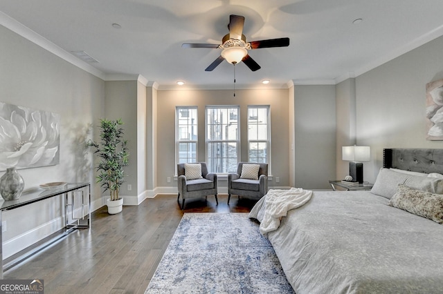 bedroom with crown molding, hardwood / wood-style floors, and ceiling fan