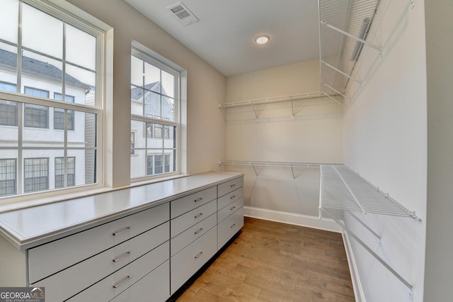 spacious closet featuring light hardwood / wood-style flooring