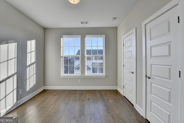 empty room featuring dark hardwood / wood-style flooring