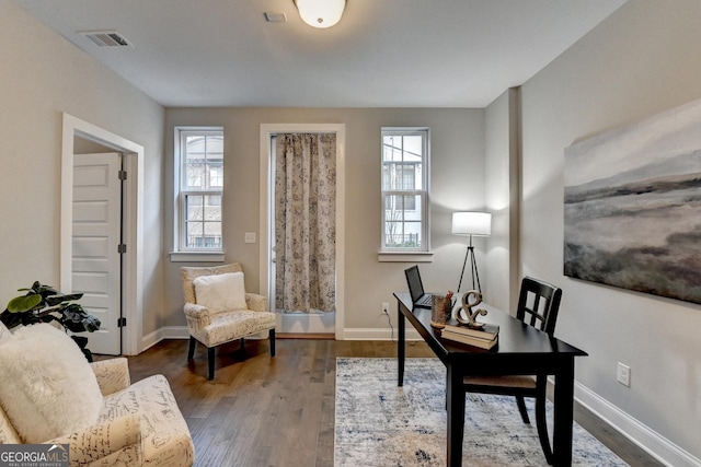 home office with dark hardwood / wood-style floors