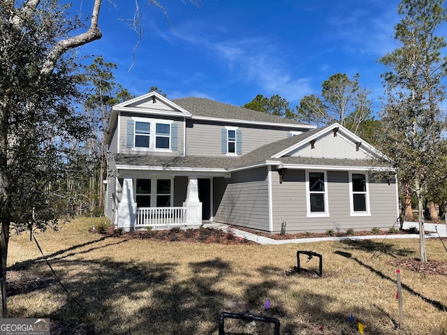 view of front of property with a front yard and covered porch