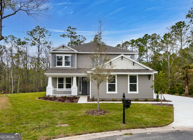 104 Encina Ct, Saint Marys, GA 31558 - view of front of home with covered porch, roof with shingles, and a front lawn