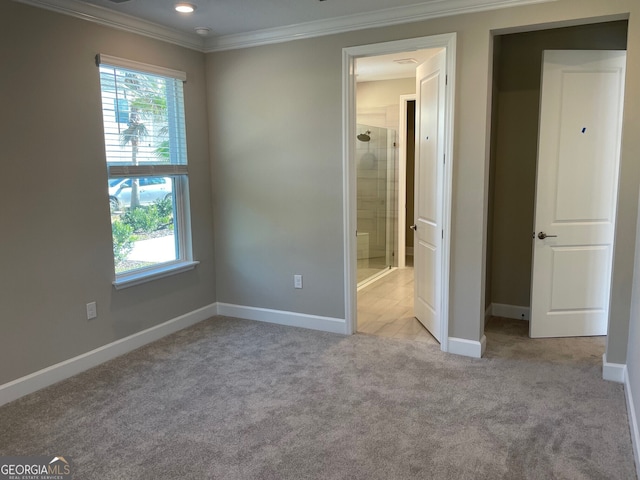 unfurnished bedroom featuring ornamental molding and light colored carpet