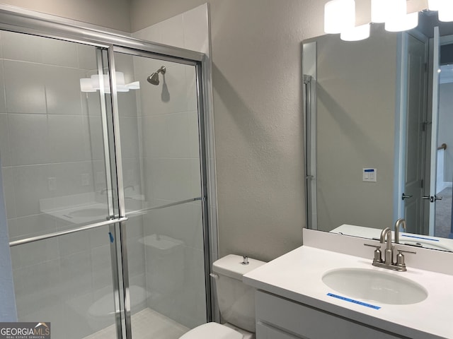 bathroom with vanity, toilet, and walk in shower