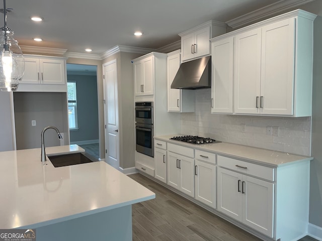 kitchen featuring sink, white cabinetry, decorative light fixtures, light hardwood / wood-style floors, and decorative backsplash