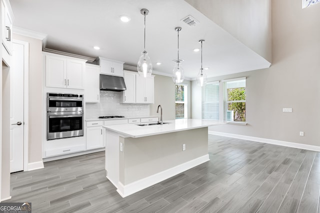 104 Encina Ct, Saint Marys, GA 31558 - kitchen with a sink, under cabinet range hood, gas cooktop, double oven, and ornamental molding
