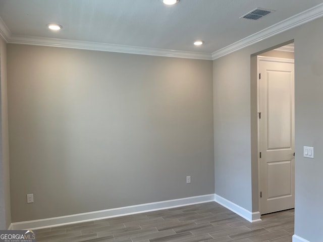 unfurnished room with crown molding