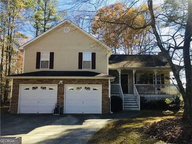 split level home with a garage and a porch