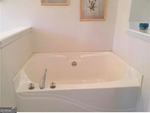 bathroom with a tub to relax in