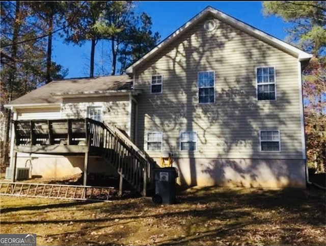 back of house with central AC and a deck