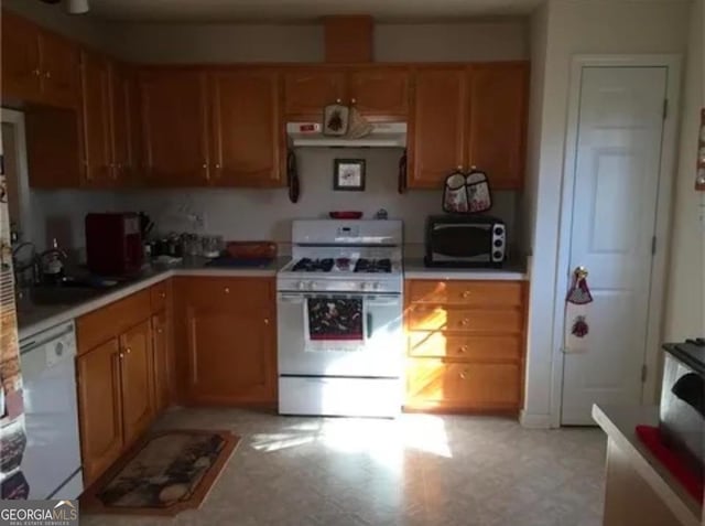 kitchen featuring sink and white appliances