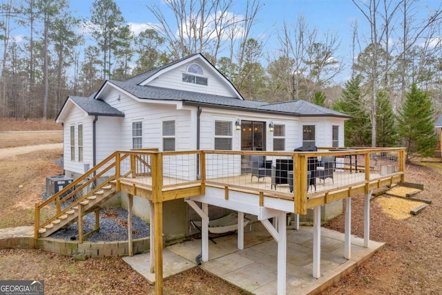 back of house with a deck and a patio area