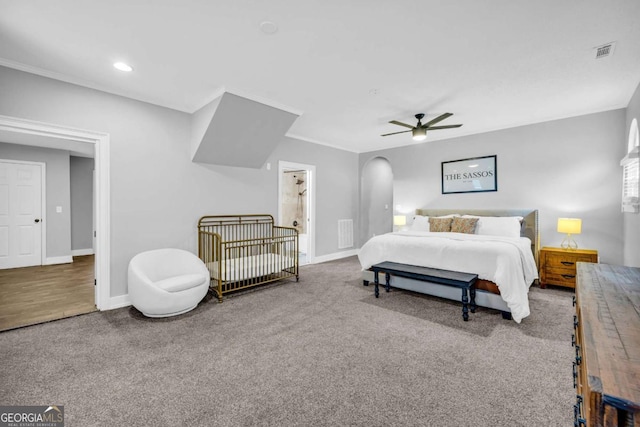 carpeted bedroom featuring ceiling fan and ensuite bathroom