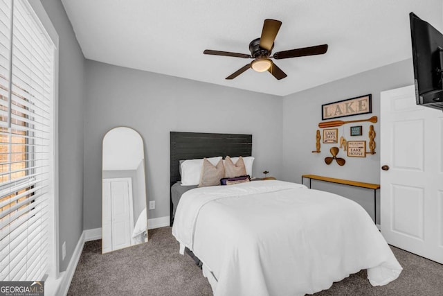 bedroom featuring ceiling fan, carpet floors, and multiple windows