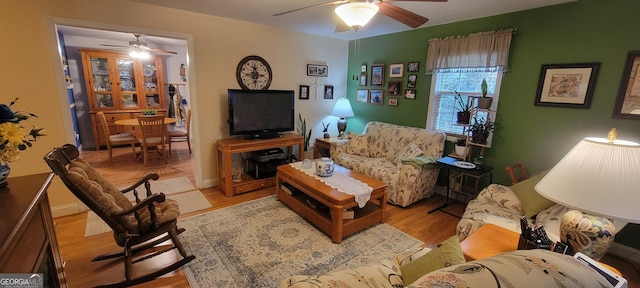 living room with ceiling fan and light hardwood / wood-style floors