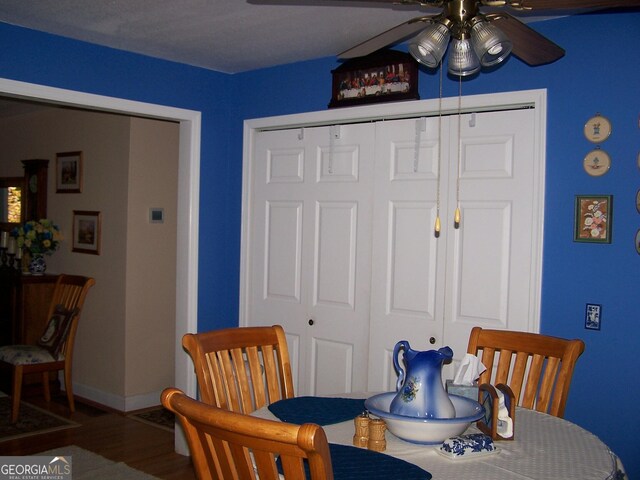 dining room with ceiling fan and wood-type flooring