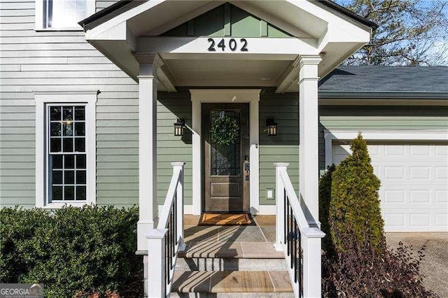 view of exterior entry with a garage