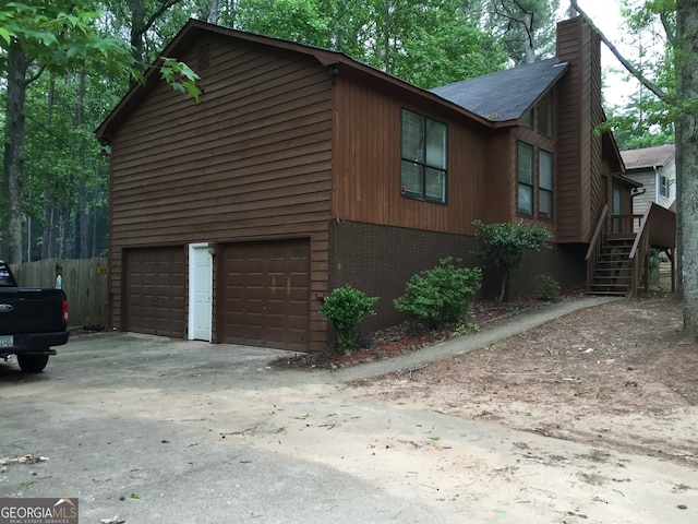 view of side of home featuring a garage