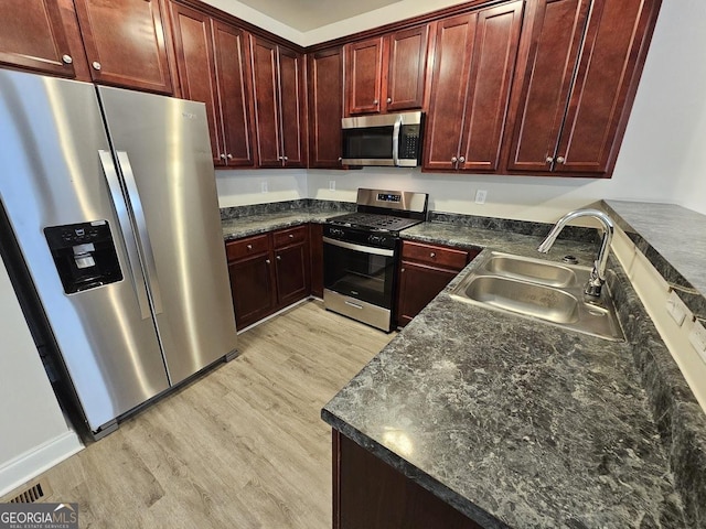 kitchen featuring sink, light hardwood / wood-style flooring, and appliances with stainless steel finishes