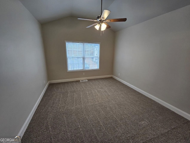 spare room with vaulted ceiling, ceiling fan, and carpet flooring