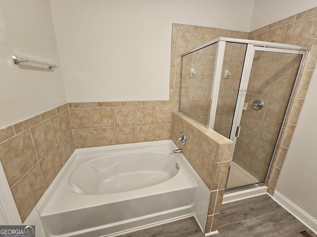 bathroom with shower with separate bathtub and hardwood / wood-style floors