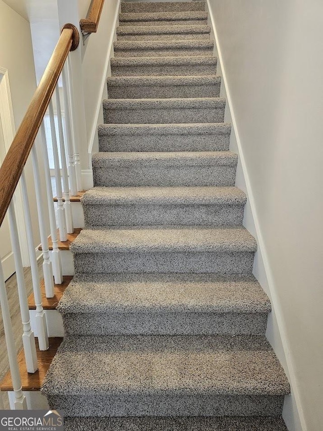 stairs with hardwood / wood-style floors