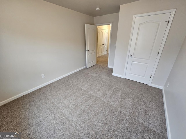 unfurnished bedroom featuring a closet and carpet