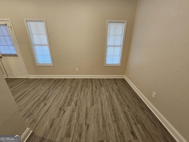 unfurnished room featuring dark wood-type flooring