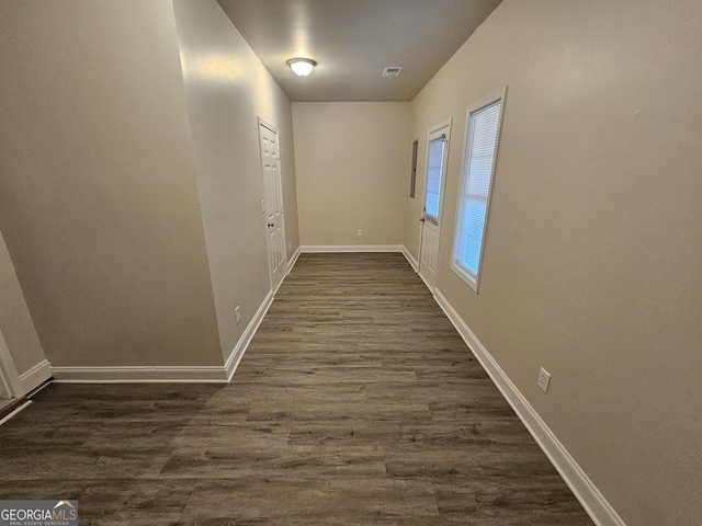 corridor with dark hardwood / wood-style floors