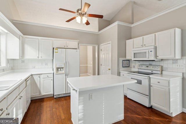 kitchen featuring a center island, white appliances, light countertops, and white cabinetry