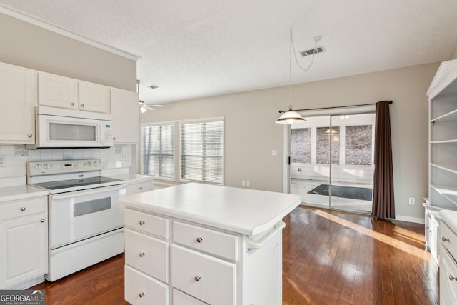 kitchen featuring white appliances, white cabinets, a kitchen island, hanging light fixtures, and light countertops