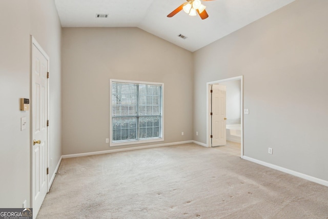 unfurnished bedroom featuring light carpet, ensuite bathroom, visible vents, and baseboards