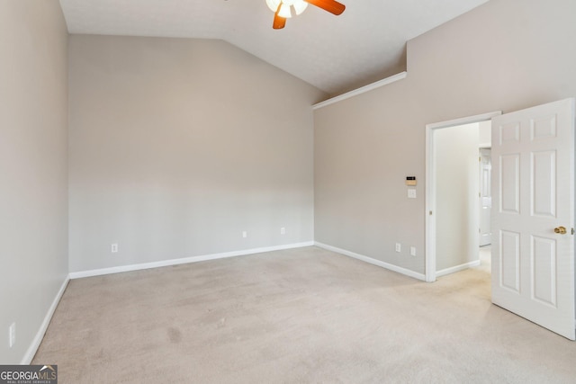 unfurnished room featuring lofted ceiling, baseboards, a ceiling fan, and light colored carpet