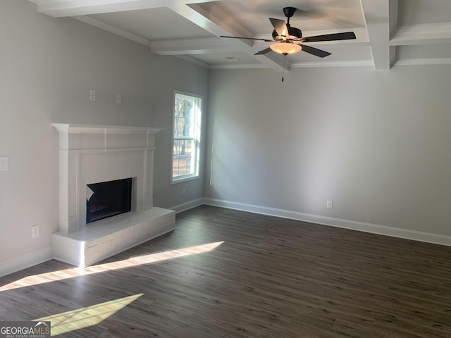 unfurnished living room with beamed ceiling, coffered ceiling, ceiling fan, a brick fireplace, and dark wood-type flooring