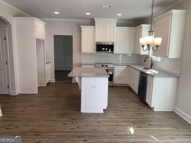 kitchen featuring white cabinetry, sink, a kitchen island, and appliances with stainless steel finishes