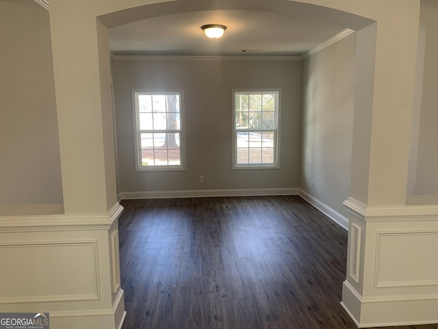 unfurnished room with dark hardwood / wood-style flooring and crown molding